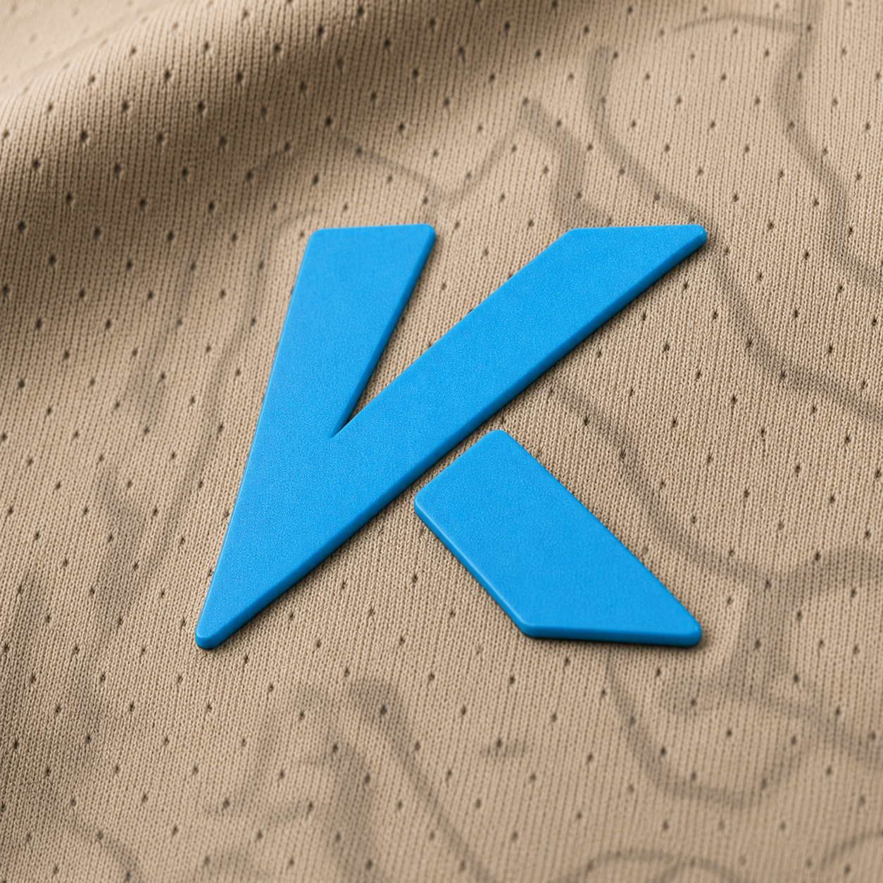 Logo Kaven Sports sobre la tela del jersey infantil Vaqueros de Agua Prieta 2026 kaki, detalle